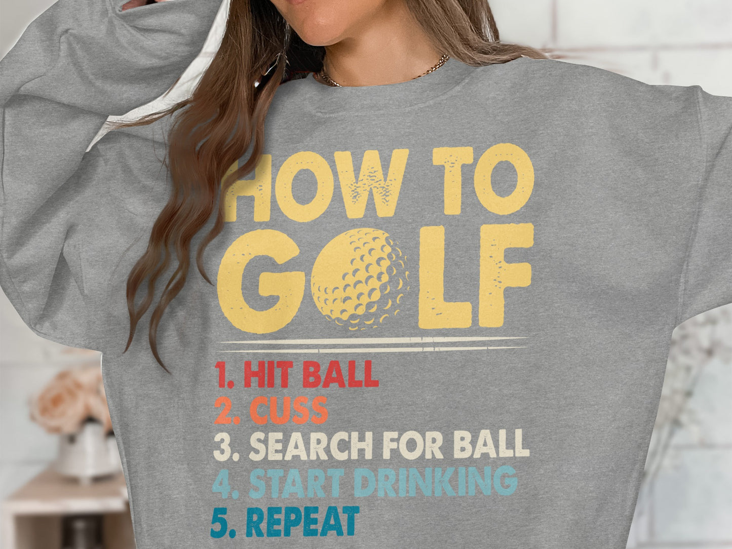 Grey sweatshirt with "HOW TO GOLF" and numbered instructions.
