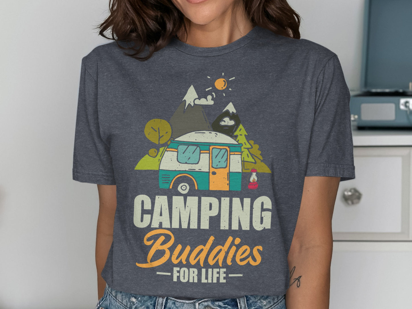 T-shirt with cartoon caravan, mountains, and text "CAMPING Buddies FOR LIFE".