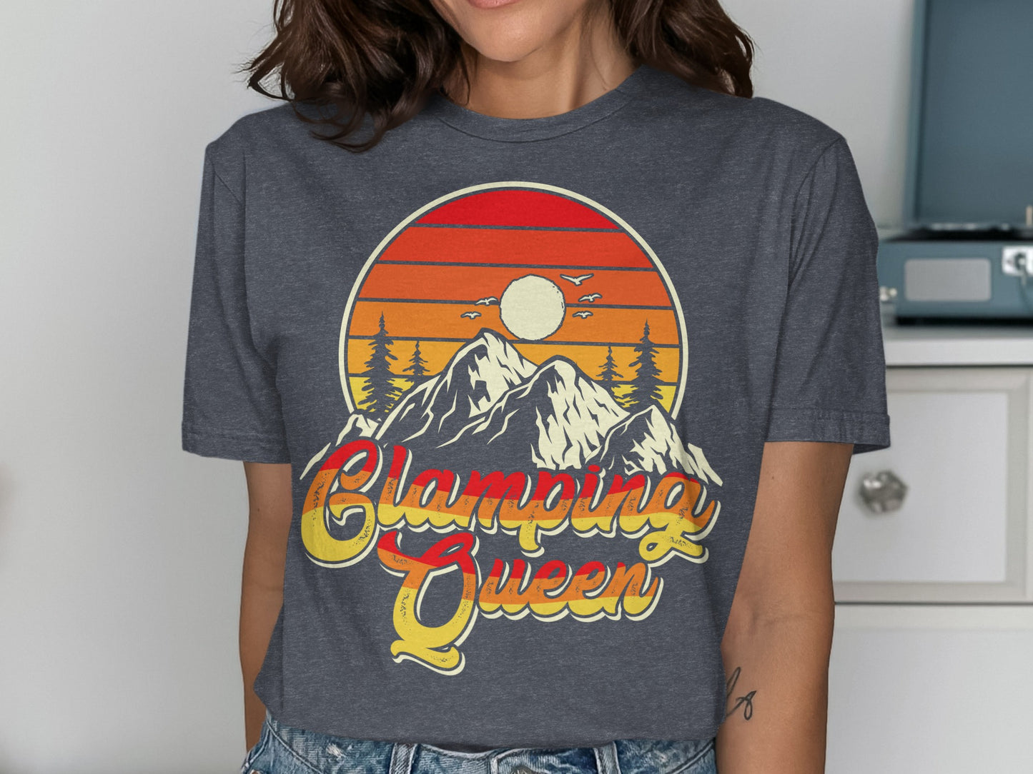 T-shirt graphic with mountains, sunset, and "Glamping Queen" text.