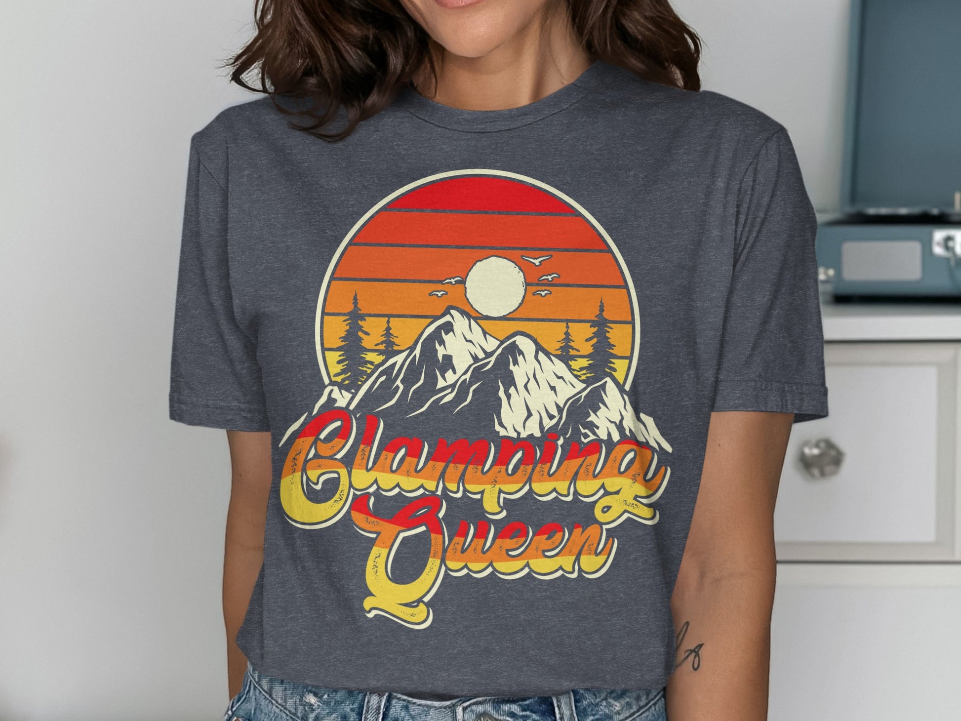 T-shirt graphic with mountains, sunset, and "Glamping Queen" text.