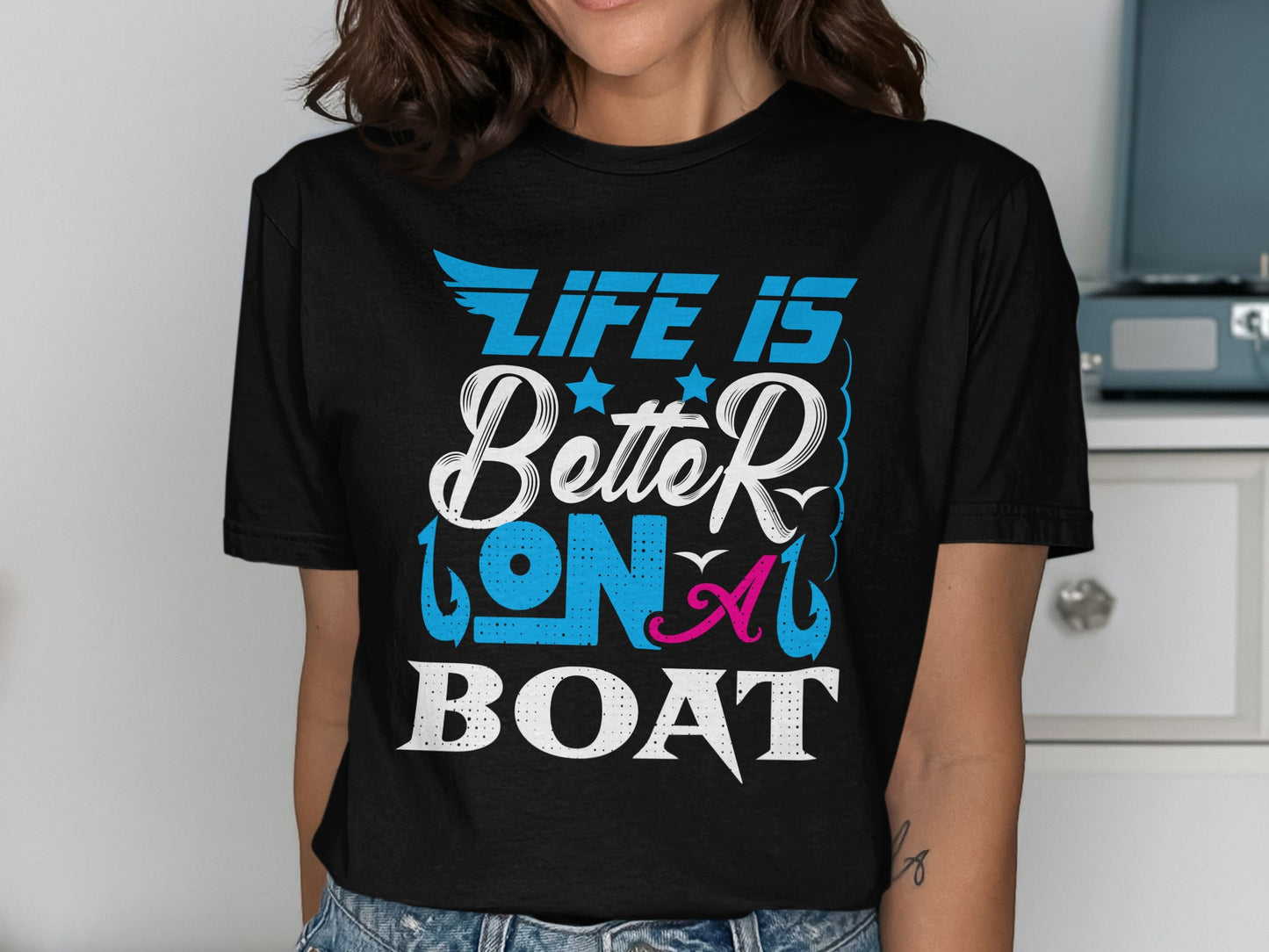 Black t-shirt with blue and pink text reading "LIFE IS Better ON A BOAT".