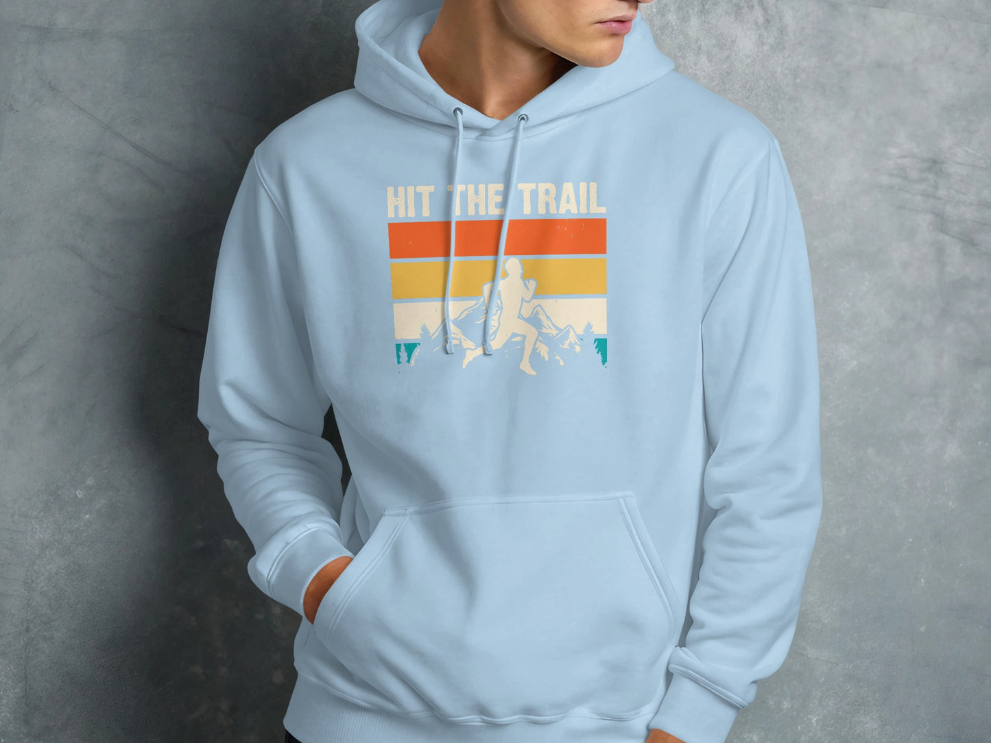 Light blue hoodie with "Hit the Trail" graphic of a runner in mountains.