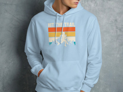 Light blue hoodie with "Hit the Trail" graphic of a runner in mountains.