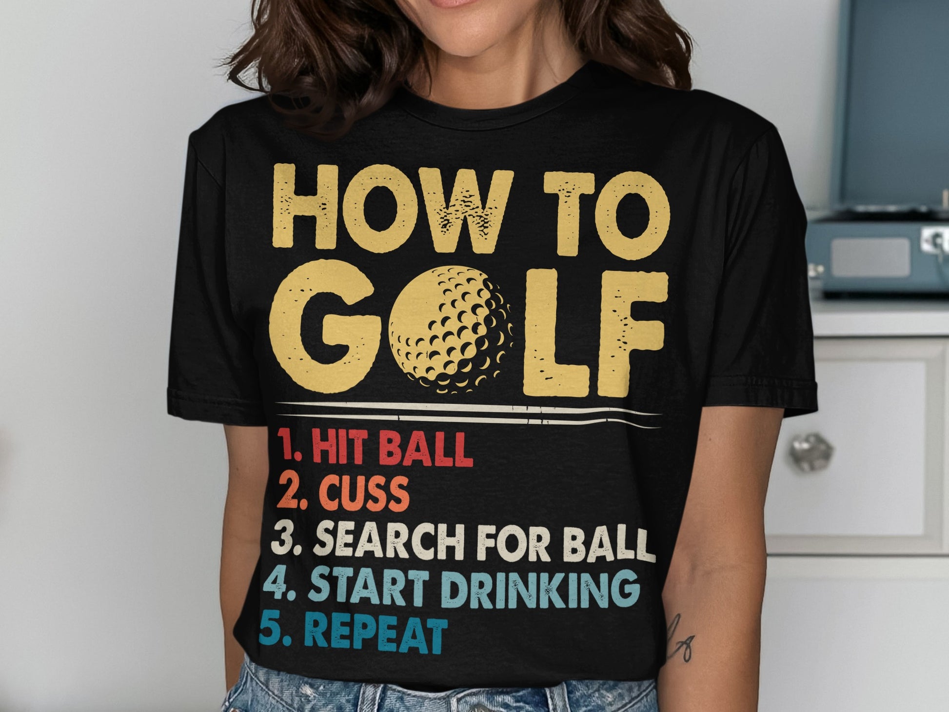 T-shirt with "HOW TO GOLF" and humorous steps: hit ball, cuss, search, drink, repeat.