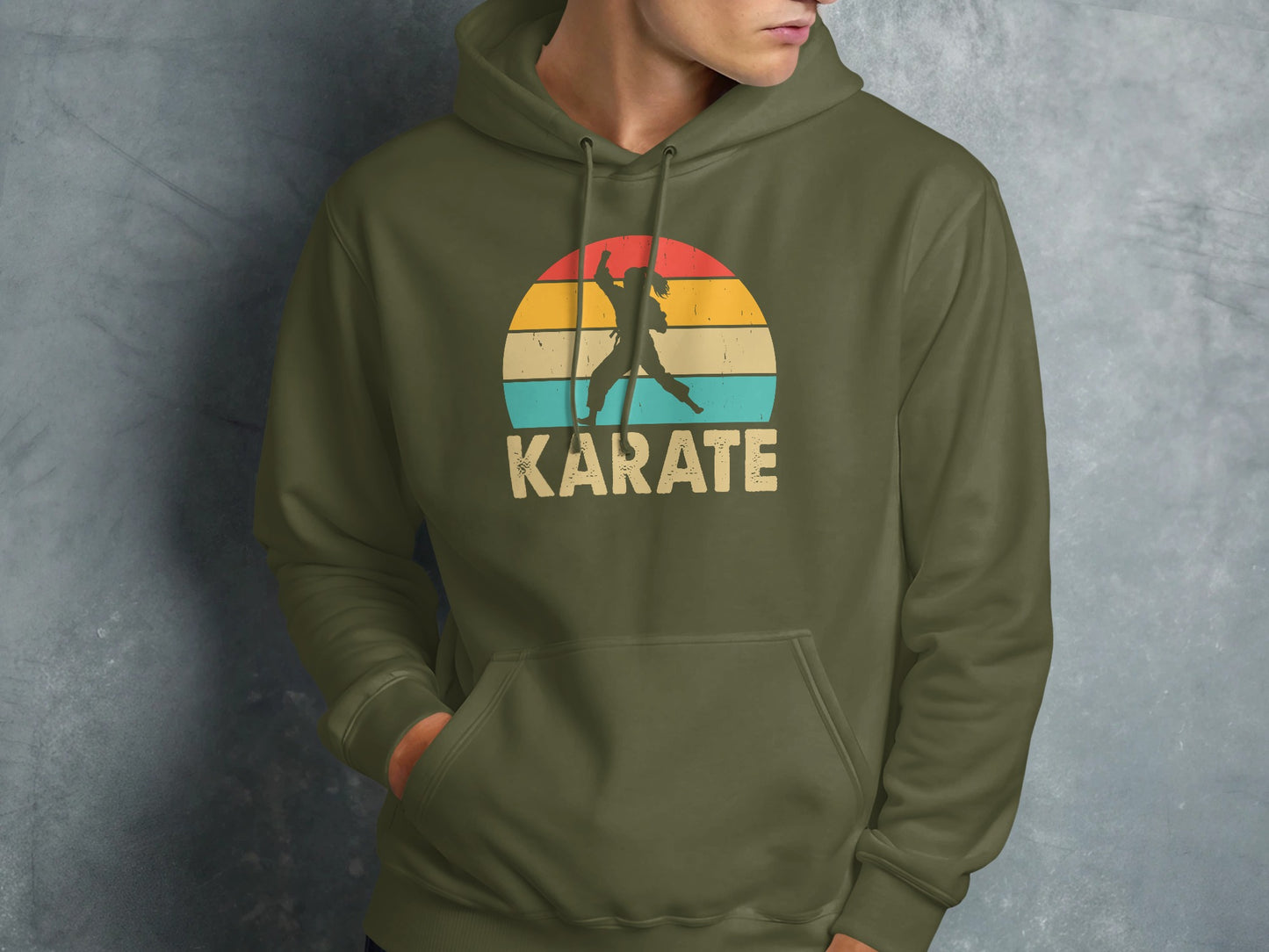 Olive green hoodie with a retro sunset karate graphic.
