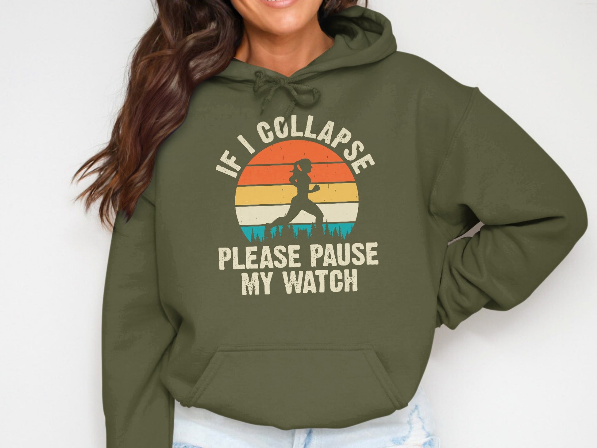 Olive hoodie with "IF I COLLAPSE PLEASE PAUSE MY WATCH" and runner silhouette.