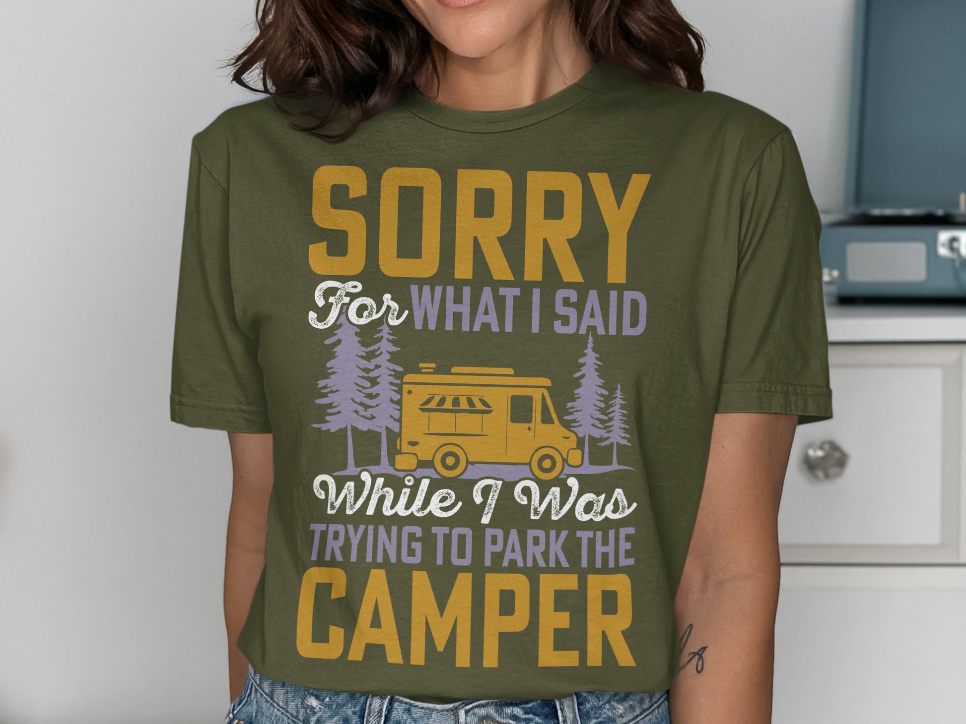 Olive green t-shirt with "Sorry for what I said while I was trying to park the camper" text.
