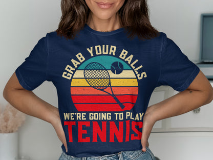 Navy t-shirt with "Grab Your Balls We're Going to Play Tennis" and retro tennis graphic.