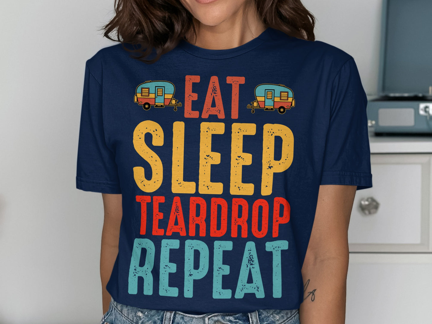 Dark blue t-shirt with "Eat Sleep Teardrop Repeat" text and teardrop camper graphics.