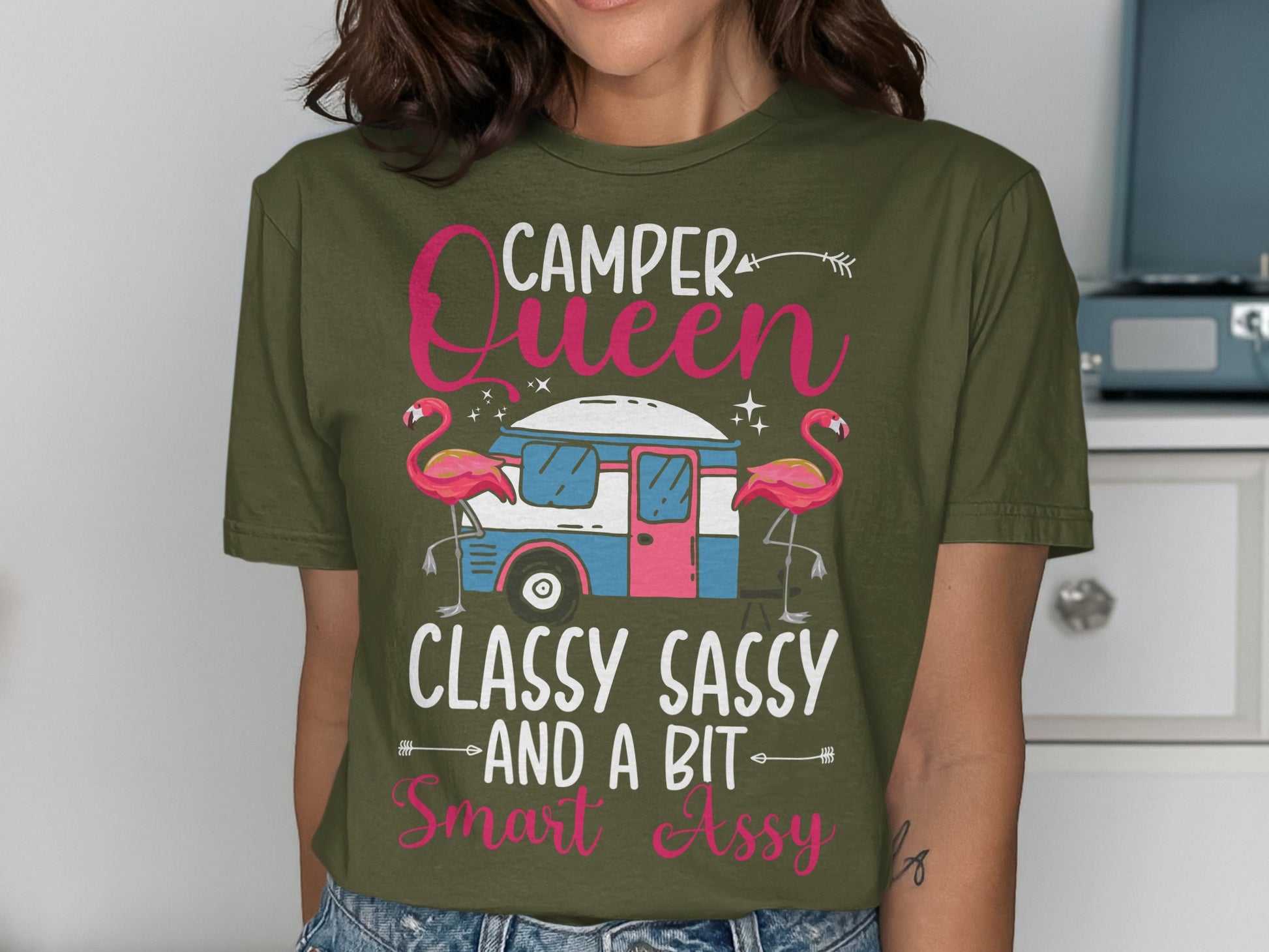 Green t-shirt with "Camper Queen Classy Sassy And A Bit Smart Ass" text and flamingoes.