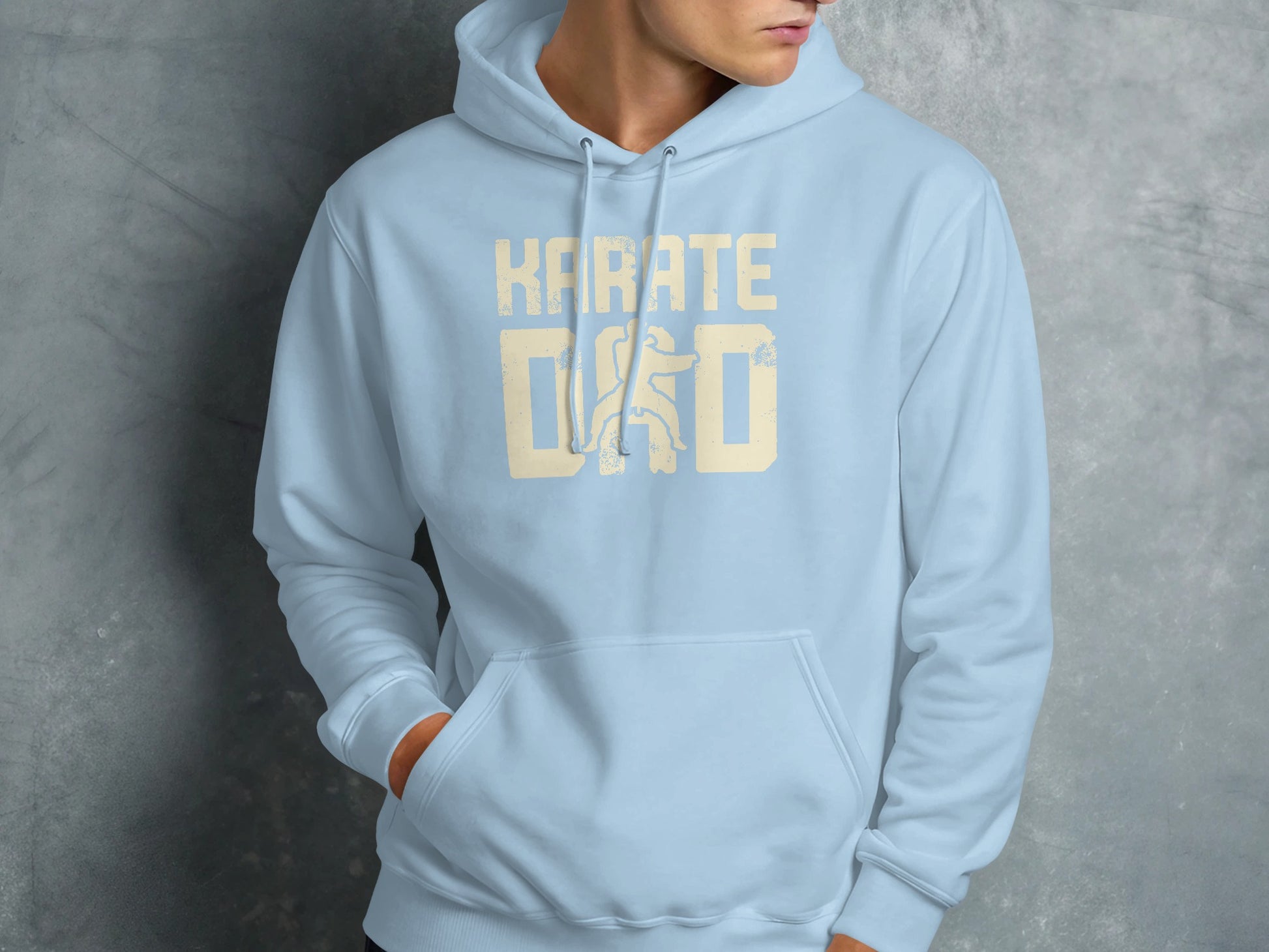 Light blue hoodie with "KARATE DAD" text on chest.