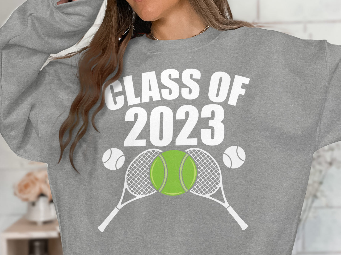 Gray sweatshirt with "CLASS OF 2023" and tennis racket and ball graphics.