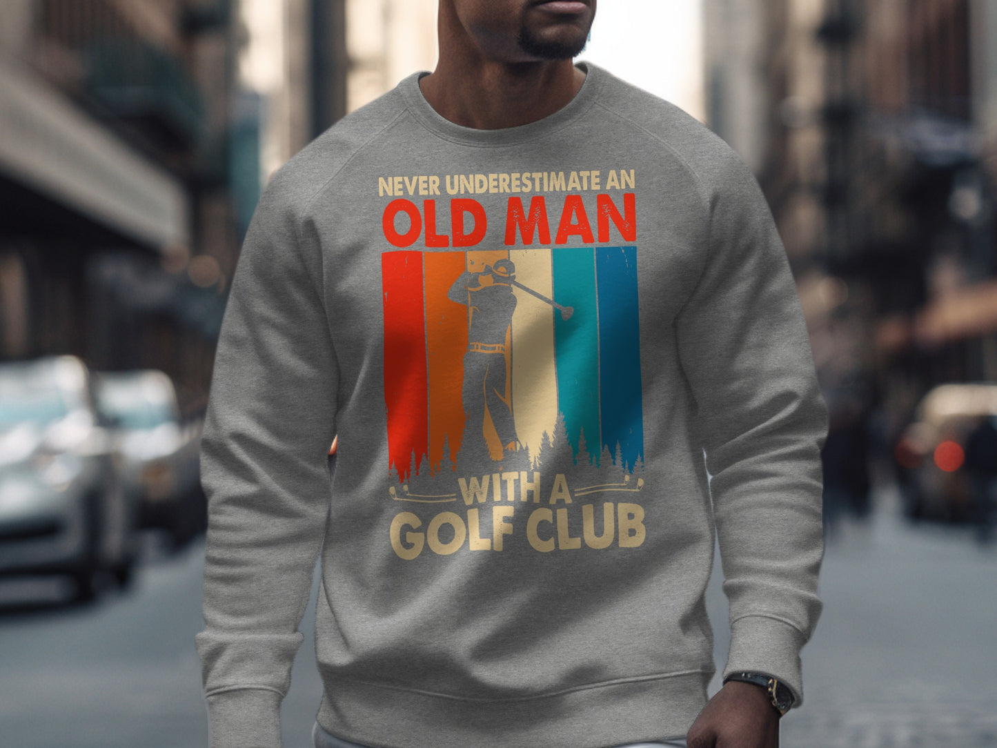 Gray sweatshirt with "Never Underestimate An Old Man With A Golf Club" text and golfer graphic.