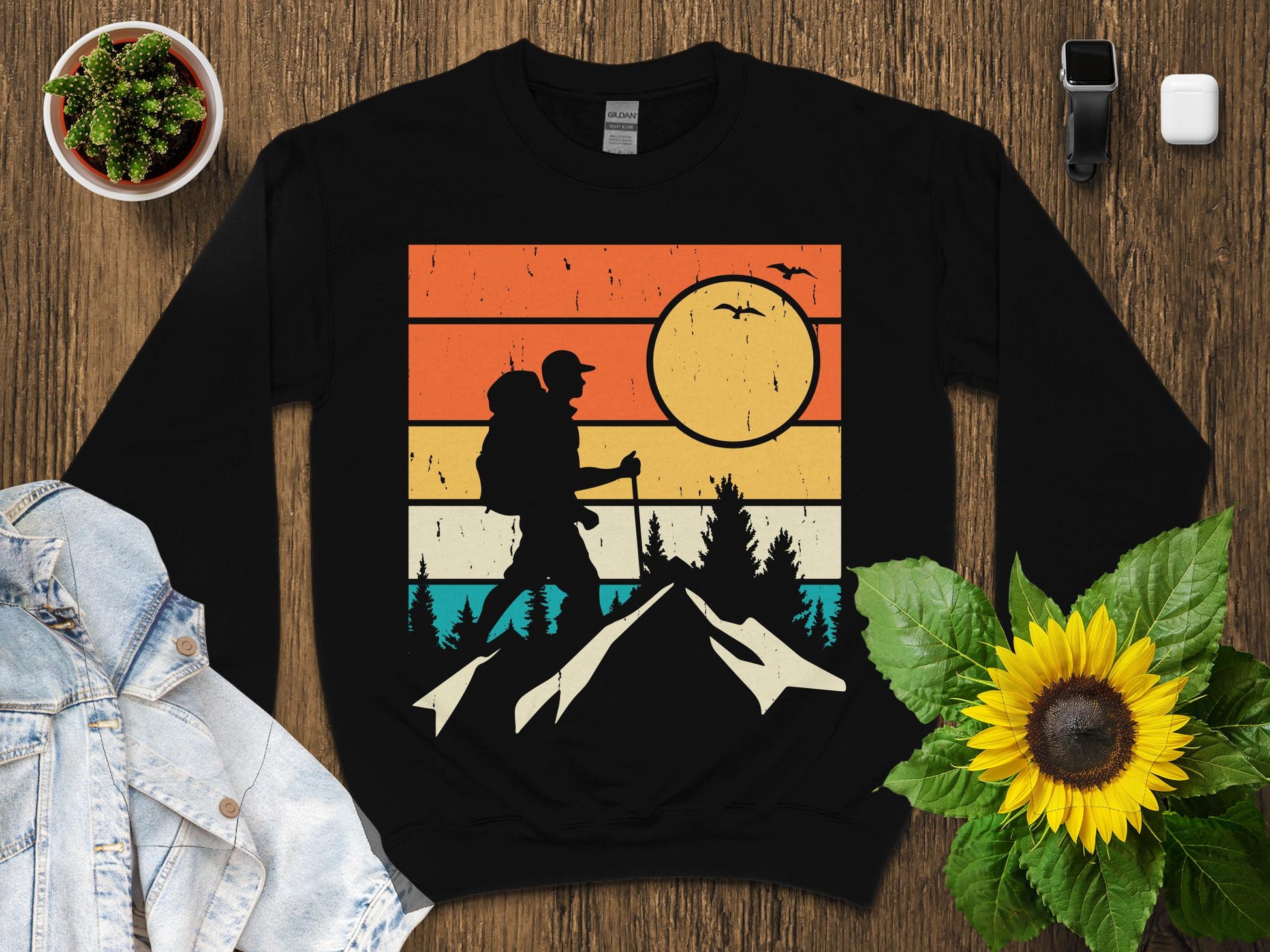 Black graphic sweatshirt featuring a vintage sunset mountain hiking scene.