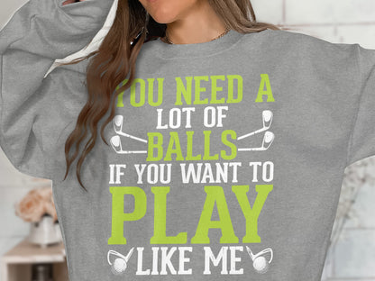 Grey sweatshirt with "You need a lot of balls if you want to play like me" text.