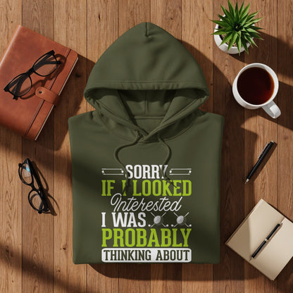 Olive green hoodie with "SORRY IF I LOOKED INTERESTED I WAS PROBABLY THINKING ABOUT GOLF" text.