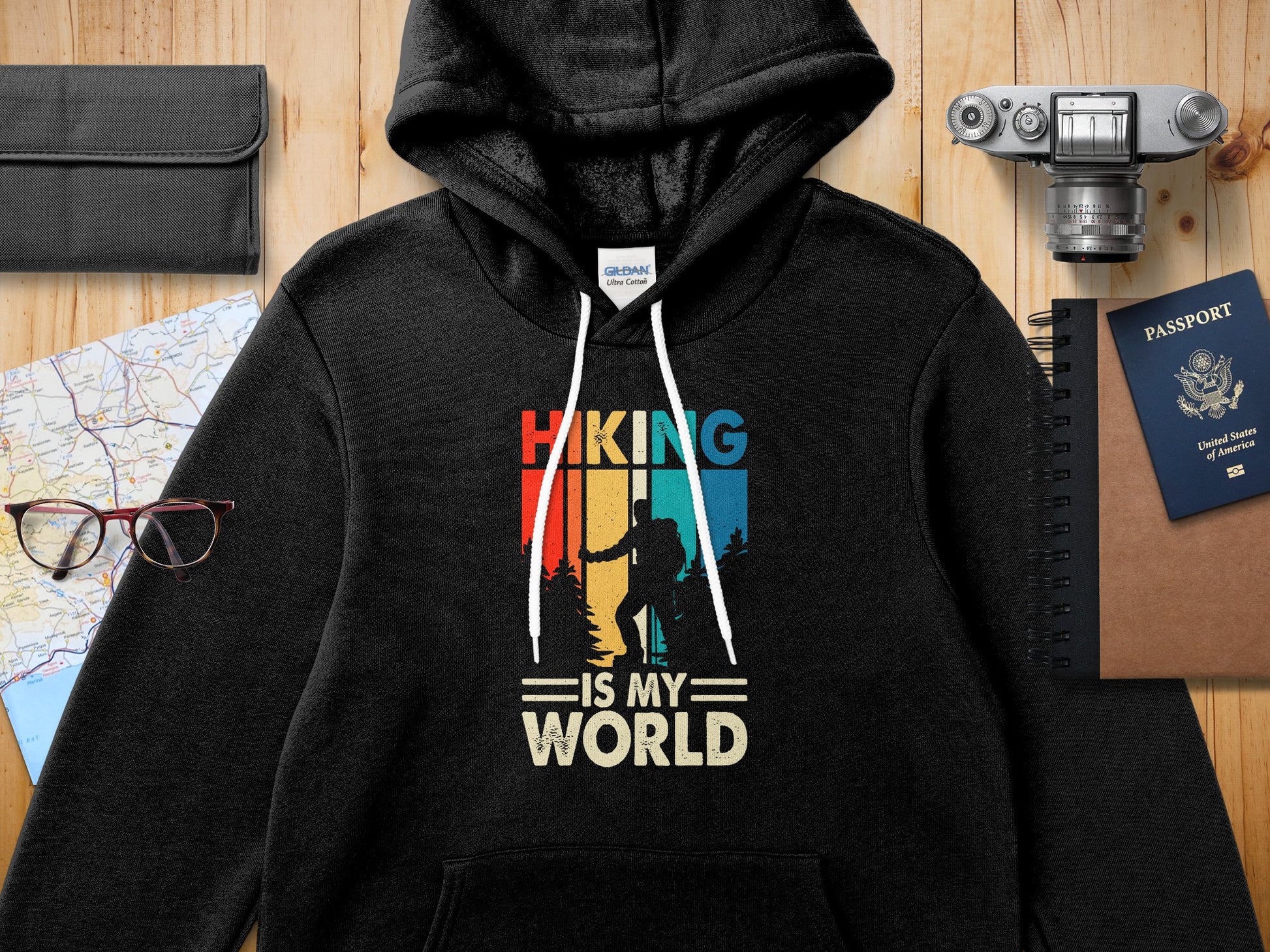 Black hoodie with "Hiking is My World" text and vintage hiker graphic.