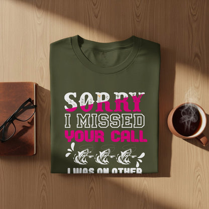 Green t-shirt with "Sorry I missed your call" and fish graphic.