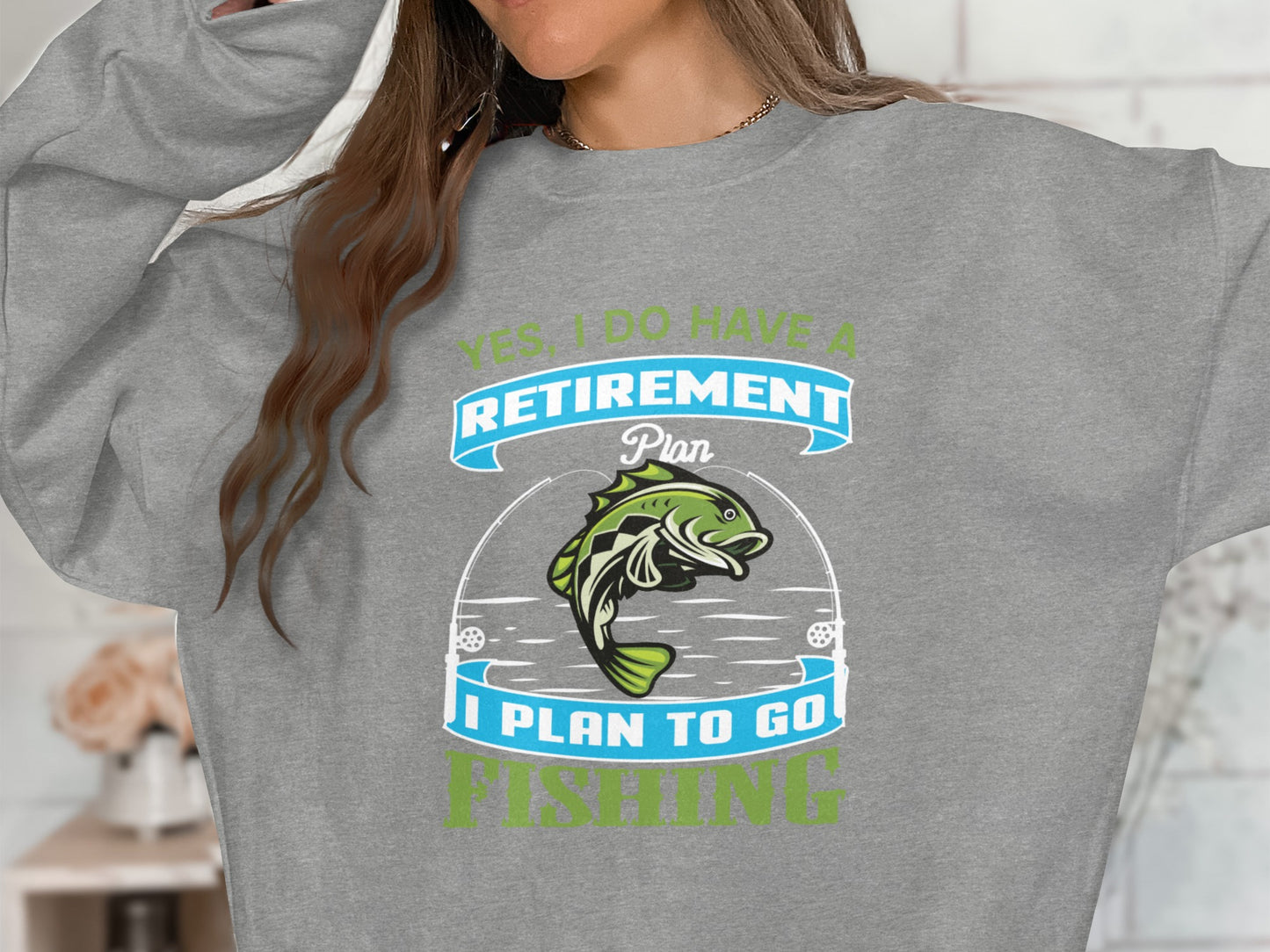 Gray sweatshirt with "Yes, I Do Have a Retirement Plan: Fishing" text and a fish graphic.