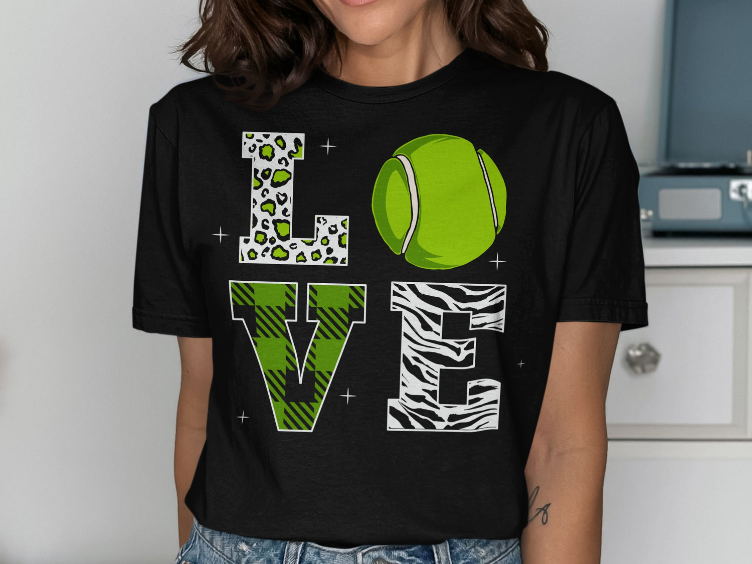 Black t-shirt with green tennis ball and "LOVE" in leopard, plaid, and zebra print.
