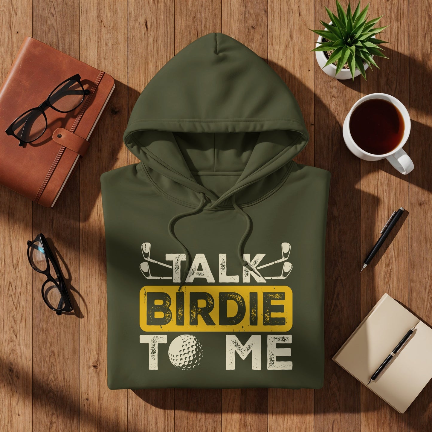 Olive green hoodie with "TALK BIRDIE TO ME" text and golf imagery.