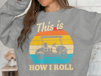 Grey sweatshirt with "This is HOW I ROLL" text and golf cart graphic.