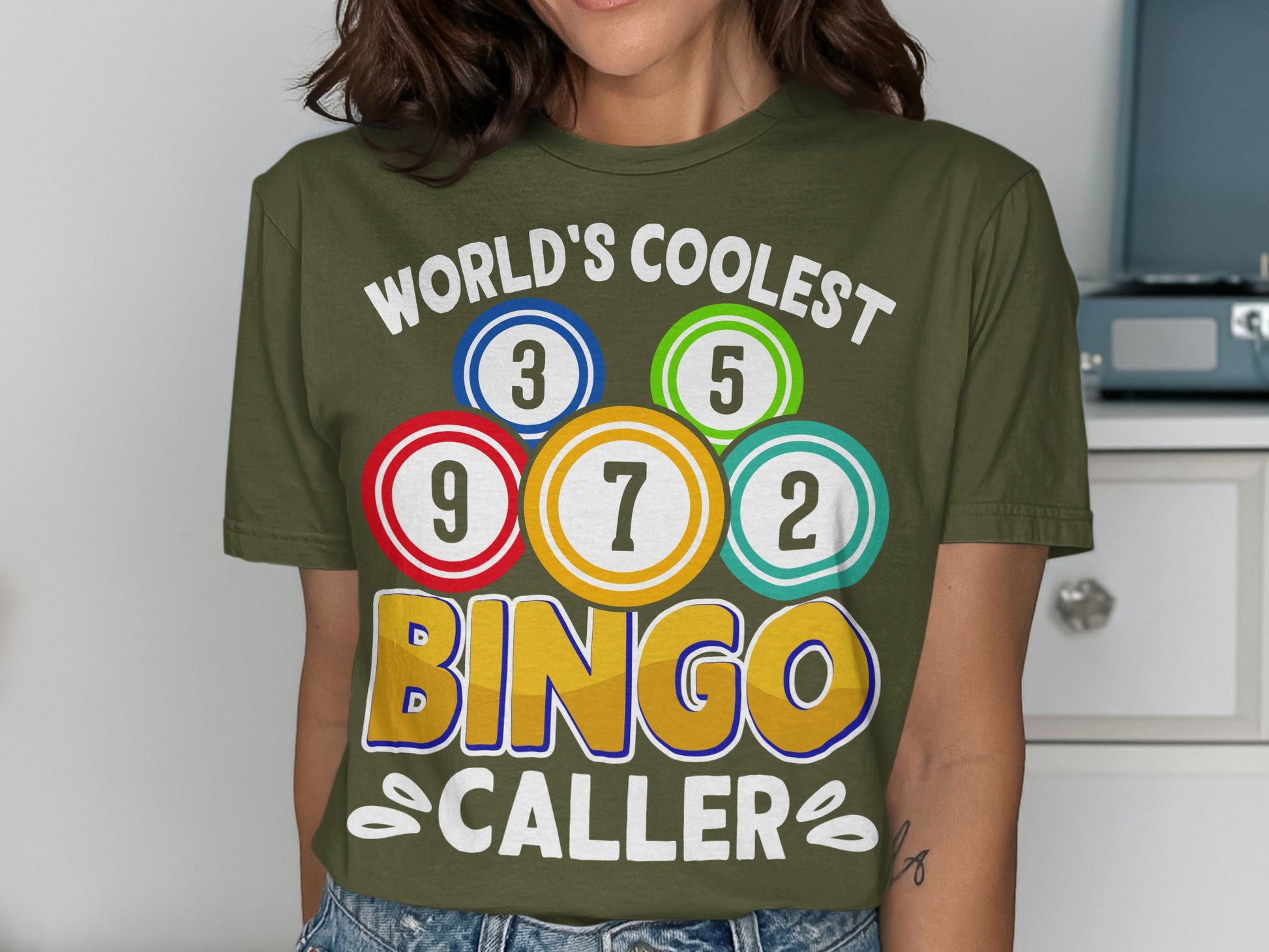 Green t-shirt with "World's Coolest Bingo Caller" and numbered bingo balls.