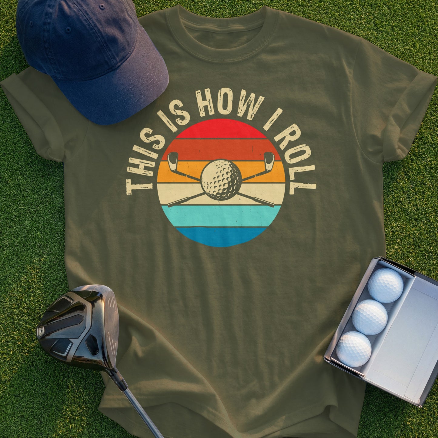 Olive t-shirt with "THIS IS HOW I ROLL" text and golf balls and clubs graphic.
