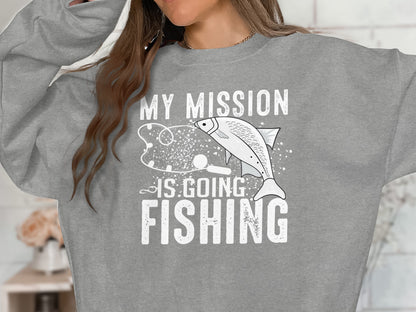 Grey sweatshirt with "MY MISSION IS GOING FISHING" and a fish illustration.