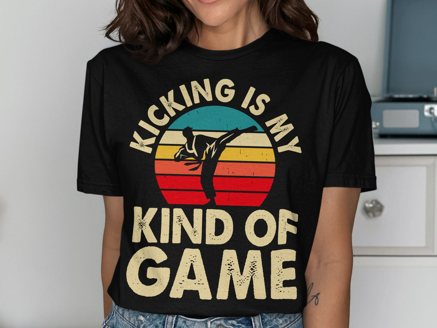 Black t-shirt with graphic of martial artist kicking and text "KICKING IS MY KIND OF GAME."