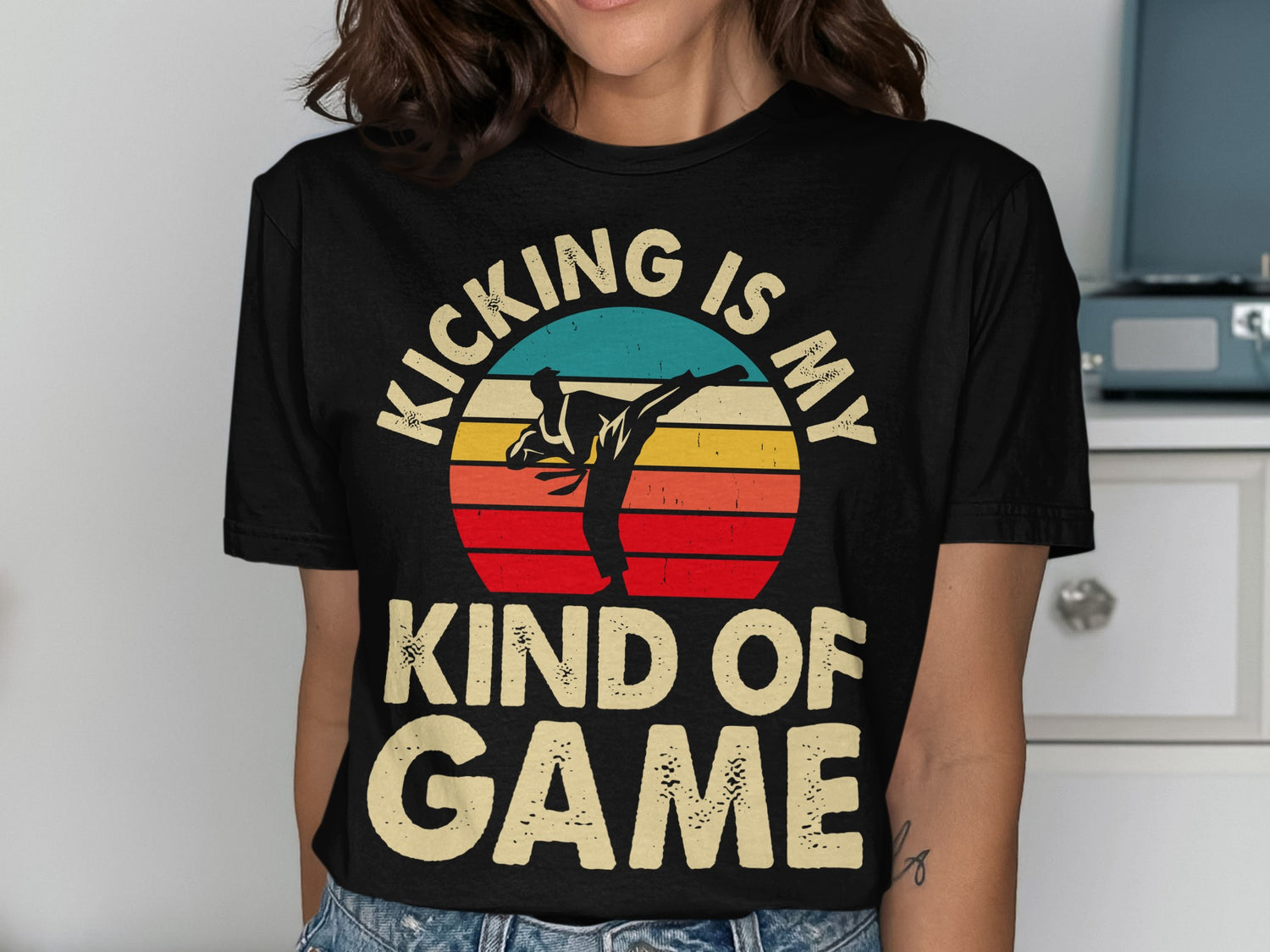 Black t-shirt with graphic of martial artist kicking and text "KICKING IS MY KIND OF GAME."