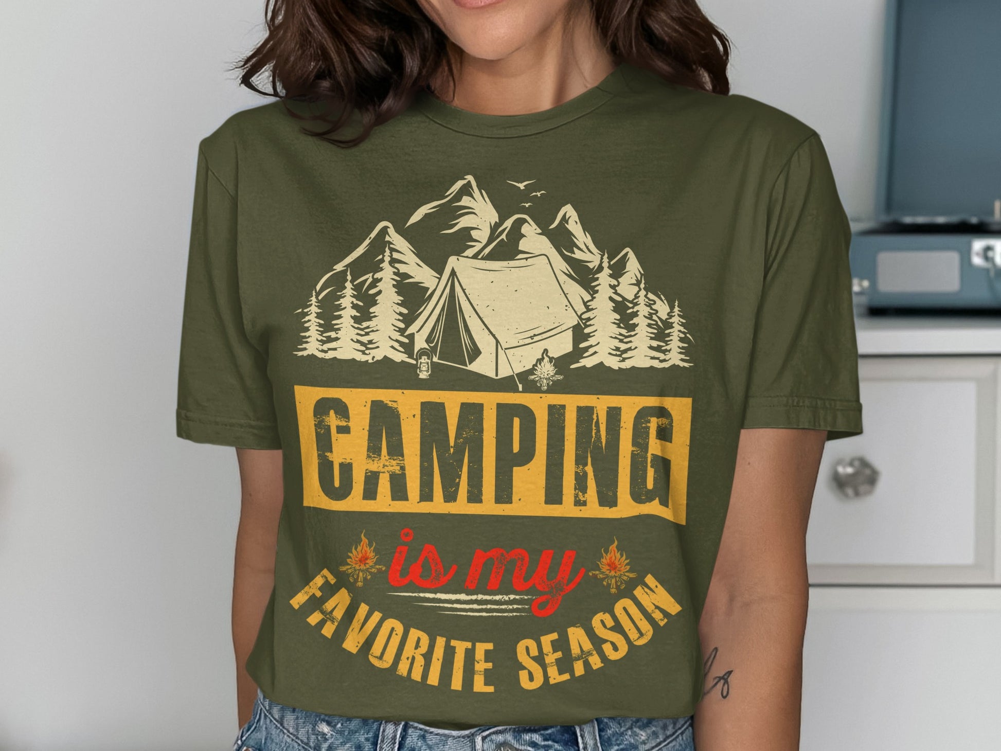 Green t-shirt with "Camping is my favorite season" text and nature graphic.
