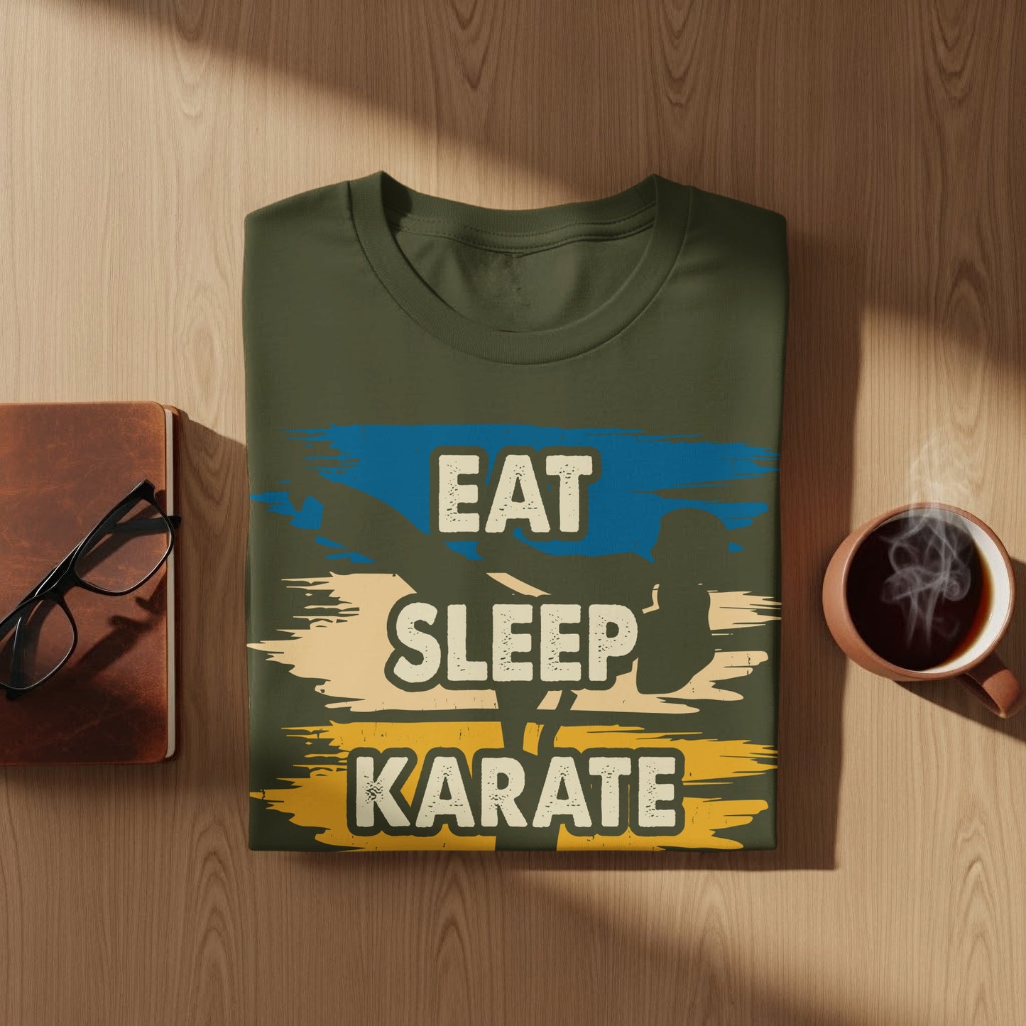 Olive green t-shirt with "Eat Sleep Karate" graphic and blue and yellow stripes.