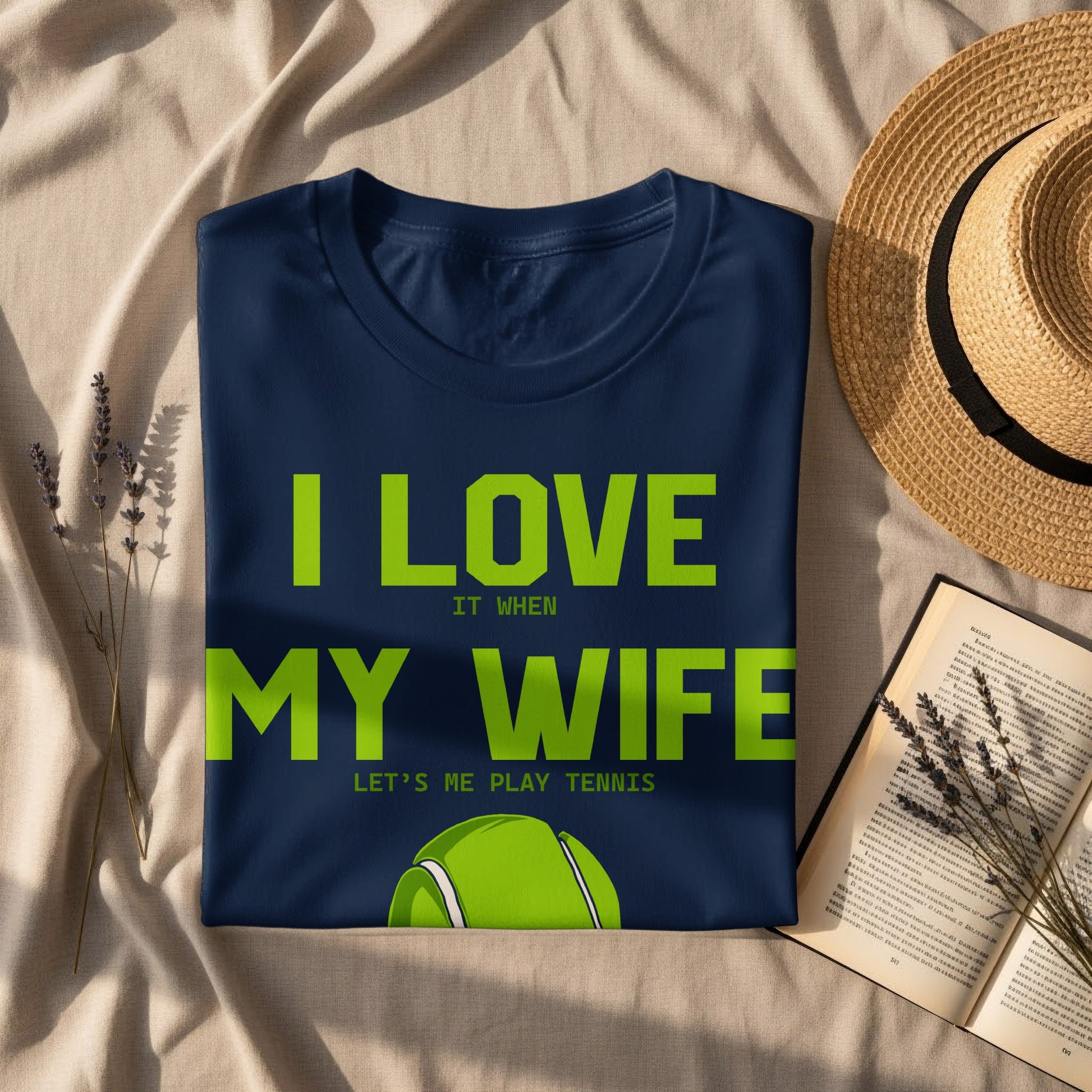 Navy t-shirt with "I LOVE MY WIFE LET'S ME PLAY TENNIS" and tennis ball graphic.