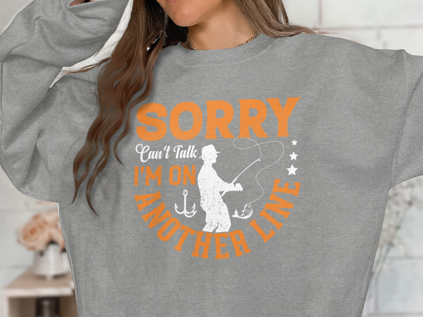 Gray sweatshirt with "Sorry I'm On Another Line" and fishing graphic.