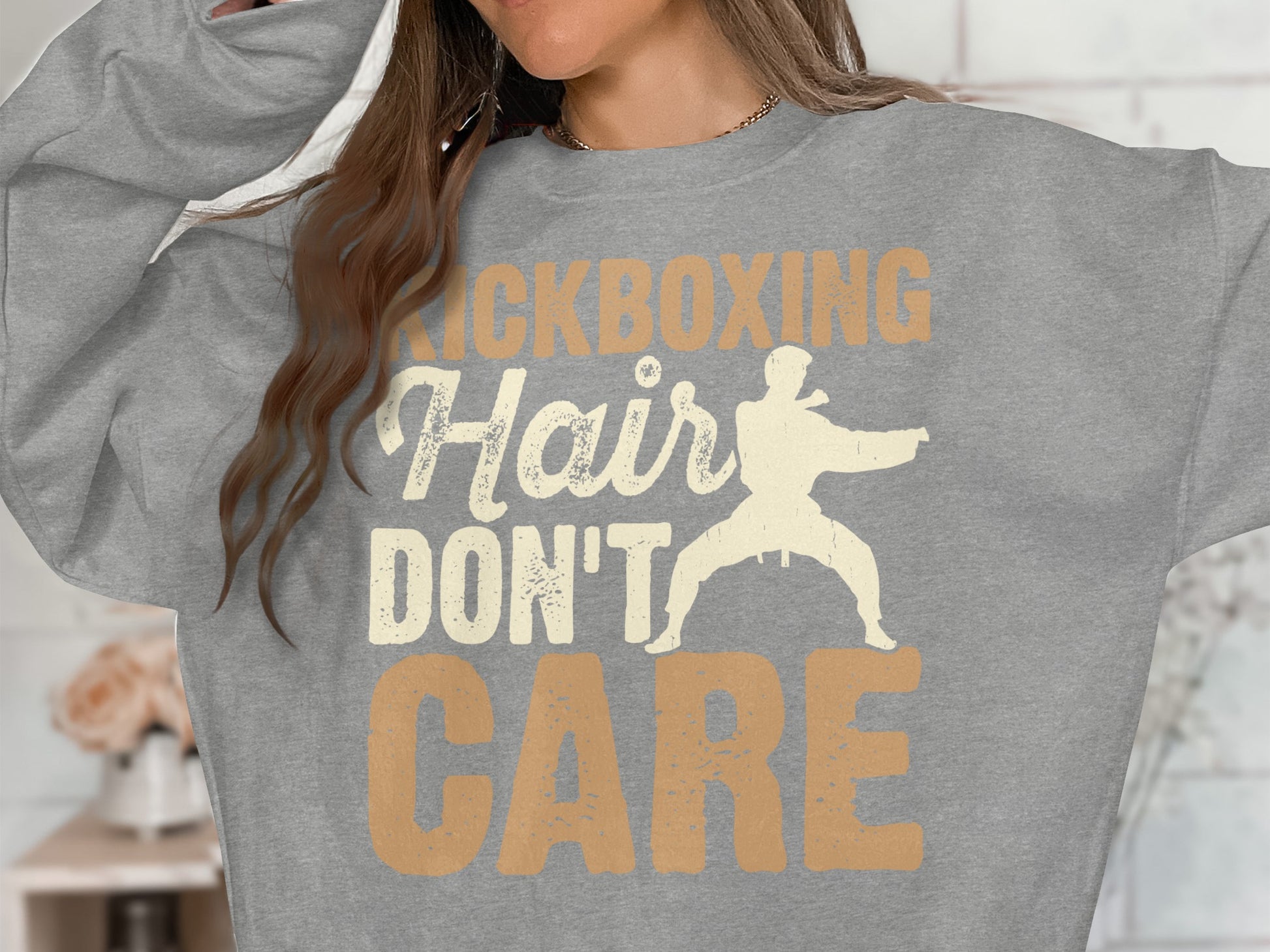 Gray sweatshirt with "Kickboxing Hair Don't Care" text and martial artist graphic.