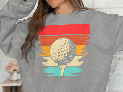 Graphic of a golf ball on a tee with colorful horizontal stripes.