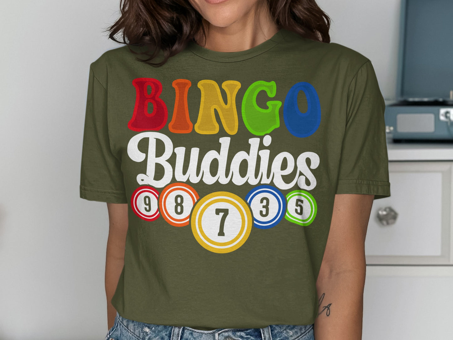 Olive green t-shirt with "BINGO Buddies" and bingo balls.