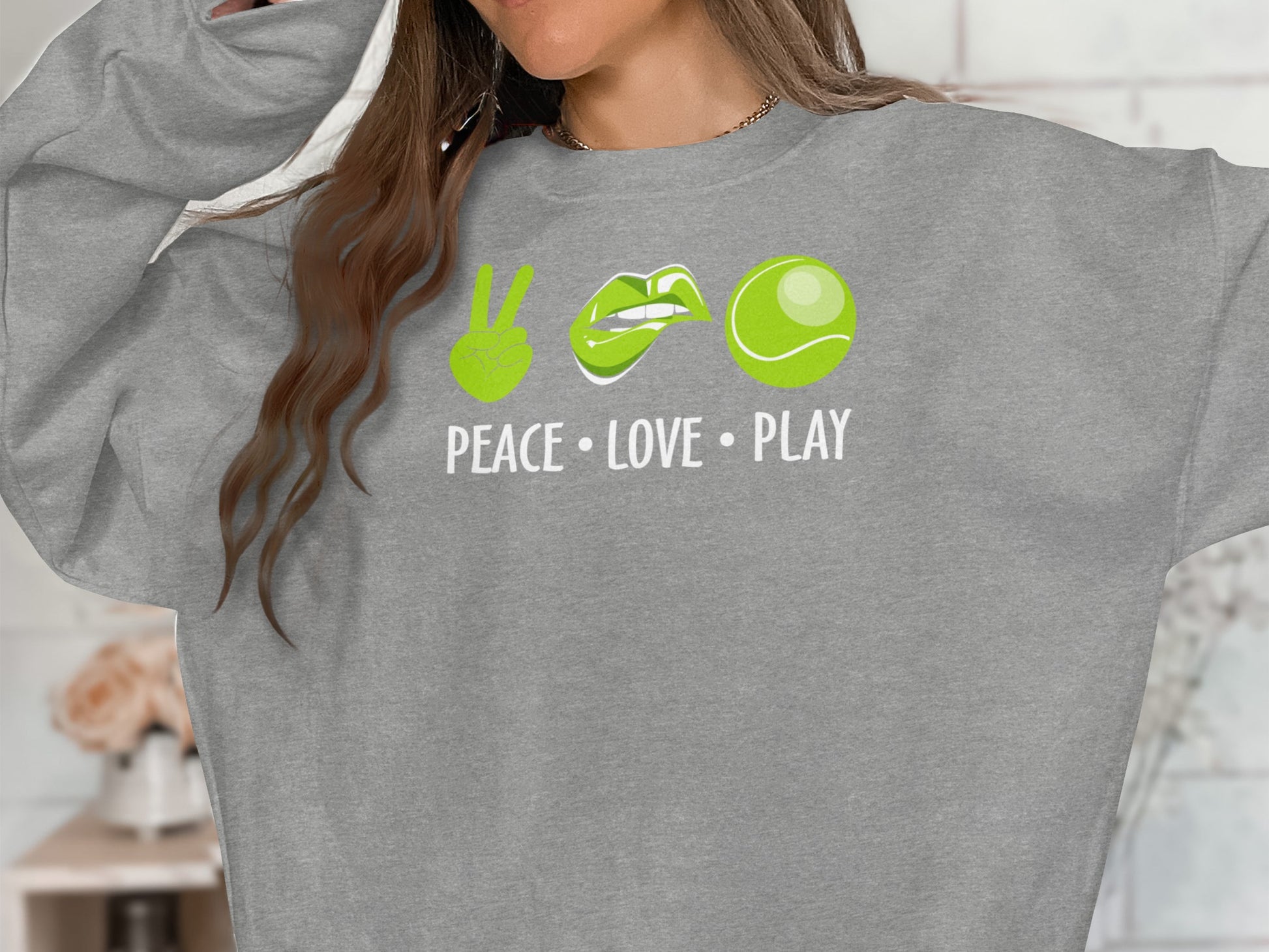 Gray sweatshirt with green peace sign, lips, tennis ball, and "PEACE LOVE PLAY".