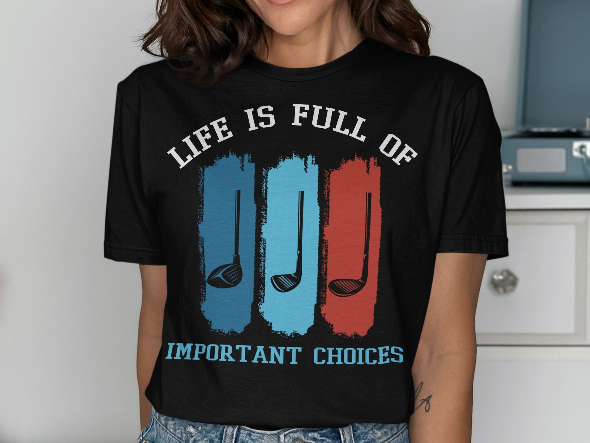 Black t-shirt with "LIFE IS FULL OF IMPORTANT CHOICES" and golf clubs.