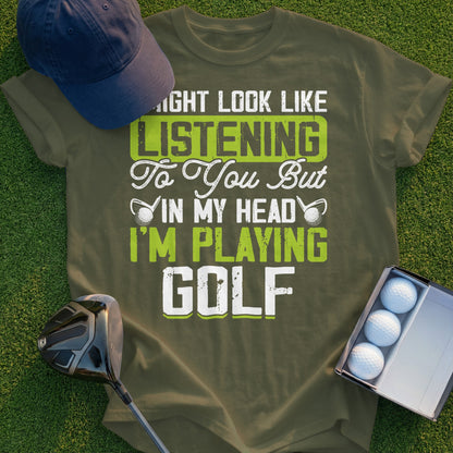 Olive green t-shirt with "I Might Look Like I'm Listening To You But In My Head I'm Playing Golf" in white and lime green text.