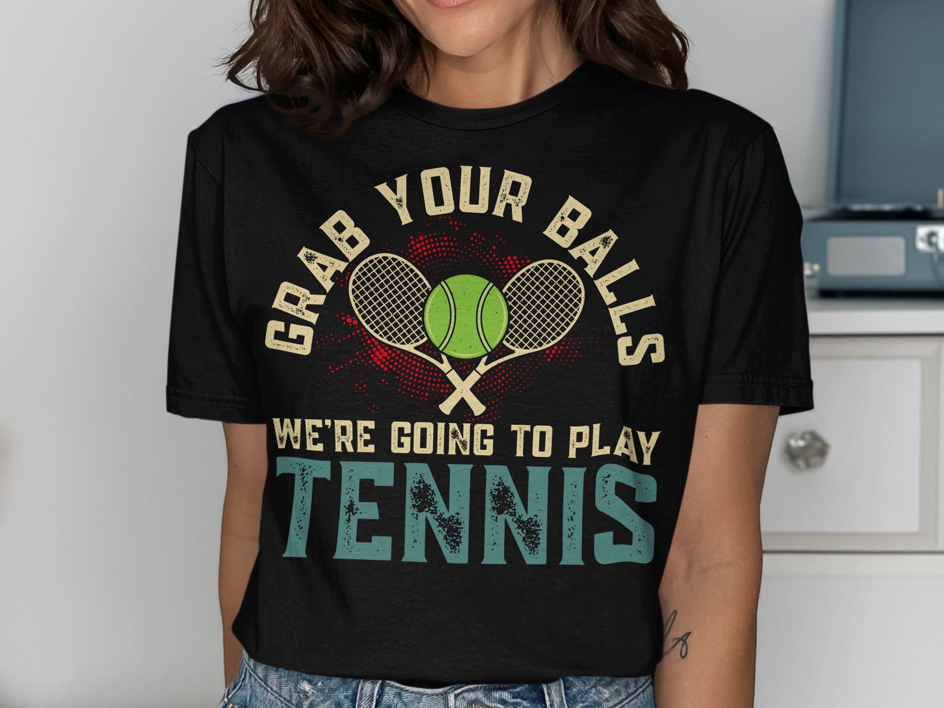 Black t-shirt with "GRAB YOUR BALLS WE'RE GOING TO PLAY TENNIS" and tennis rackets.