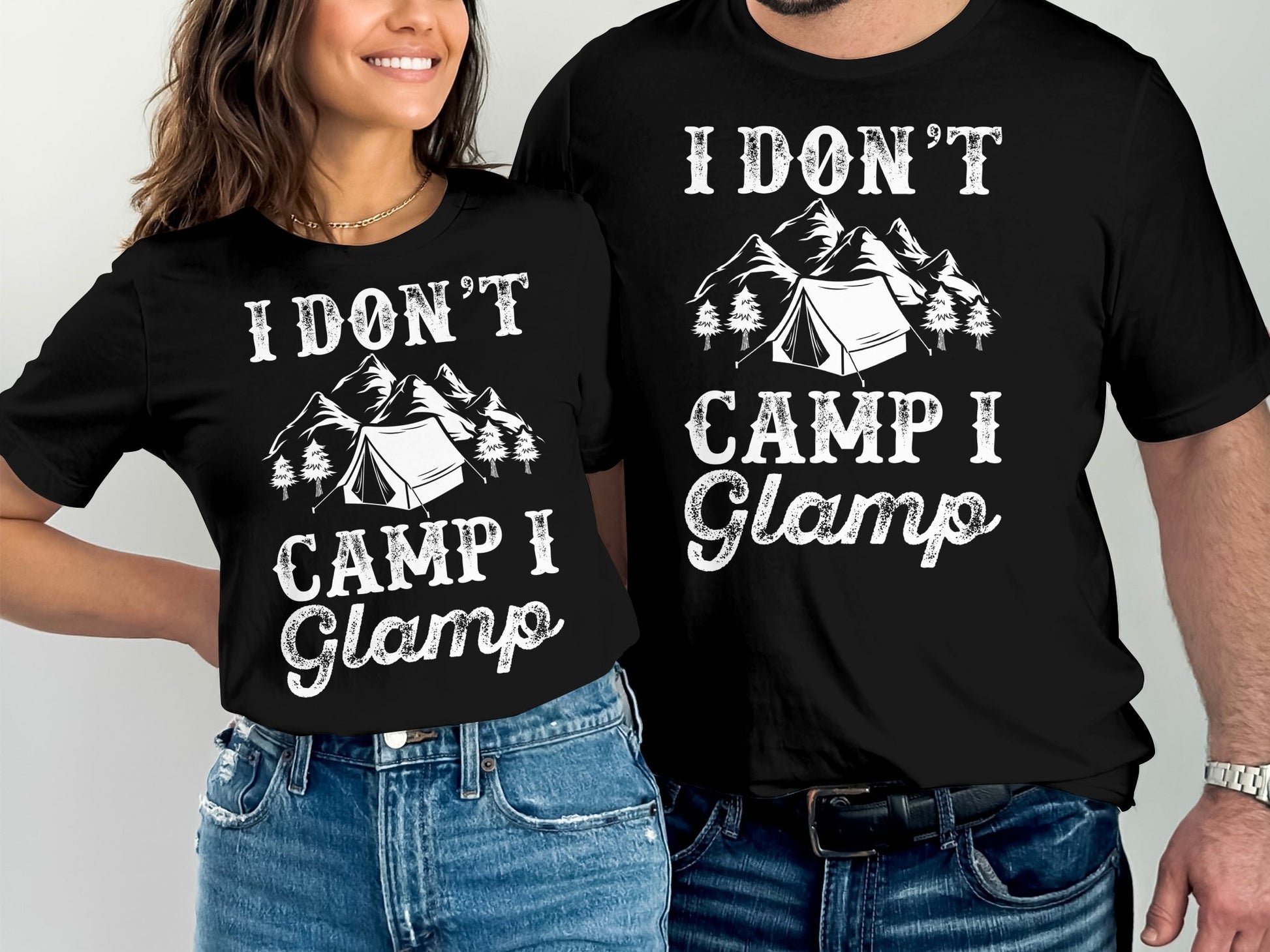 Two people wearing black t-shirts with "I Don't Camp I Glamp" and tent graphic.