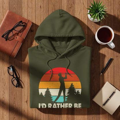 Green hoodie with "I'd Rather Be" golf graphic and sunset trees.