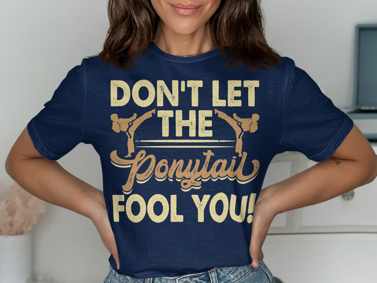 Navy t-shirt with "Don't Let The Ponytail Fool You!" text.