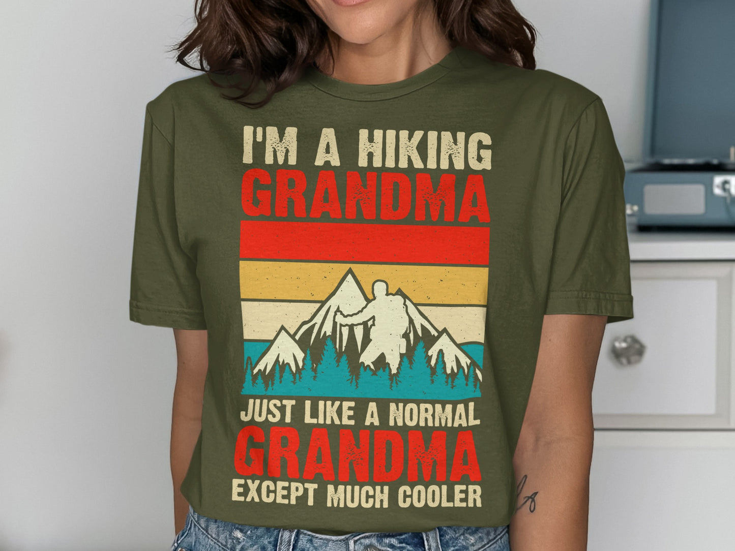 T-shirt with text "I'm a hiking grandma, just like a normal grandma except much cooler" and mountain graphic.