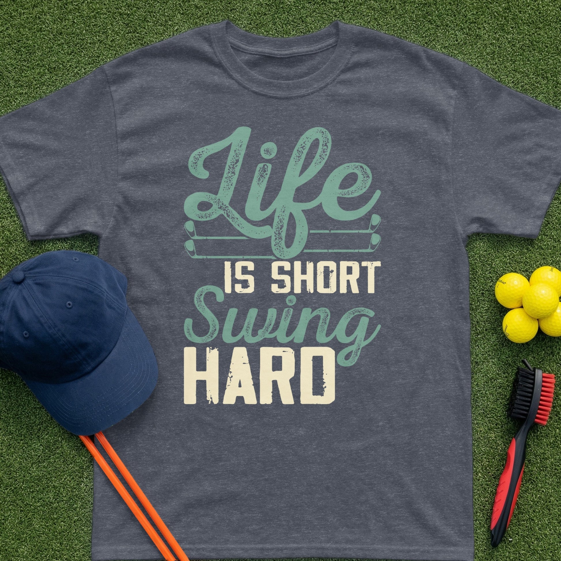 Dark grey t-shirt with "Life is Short Swing Hard" text and golf items.