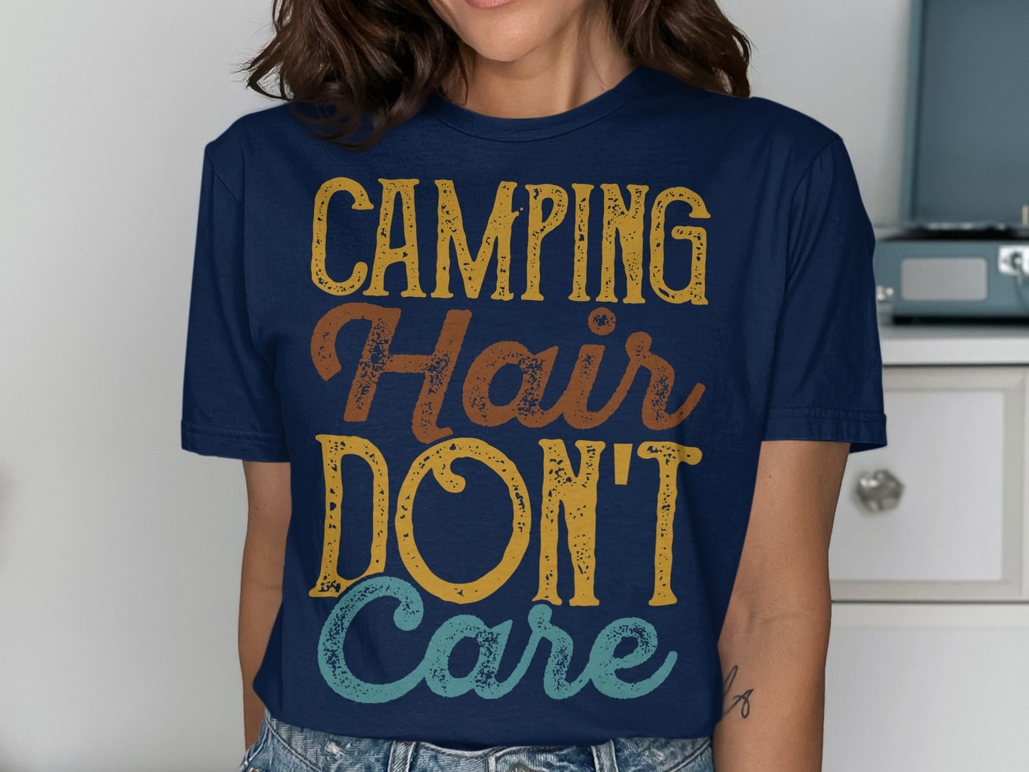 Navy t-shirt with "Camping Hair Don't Care" text.