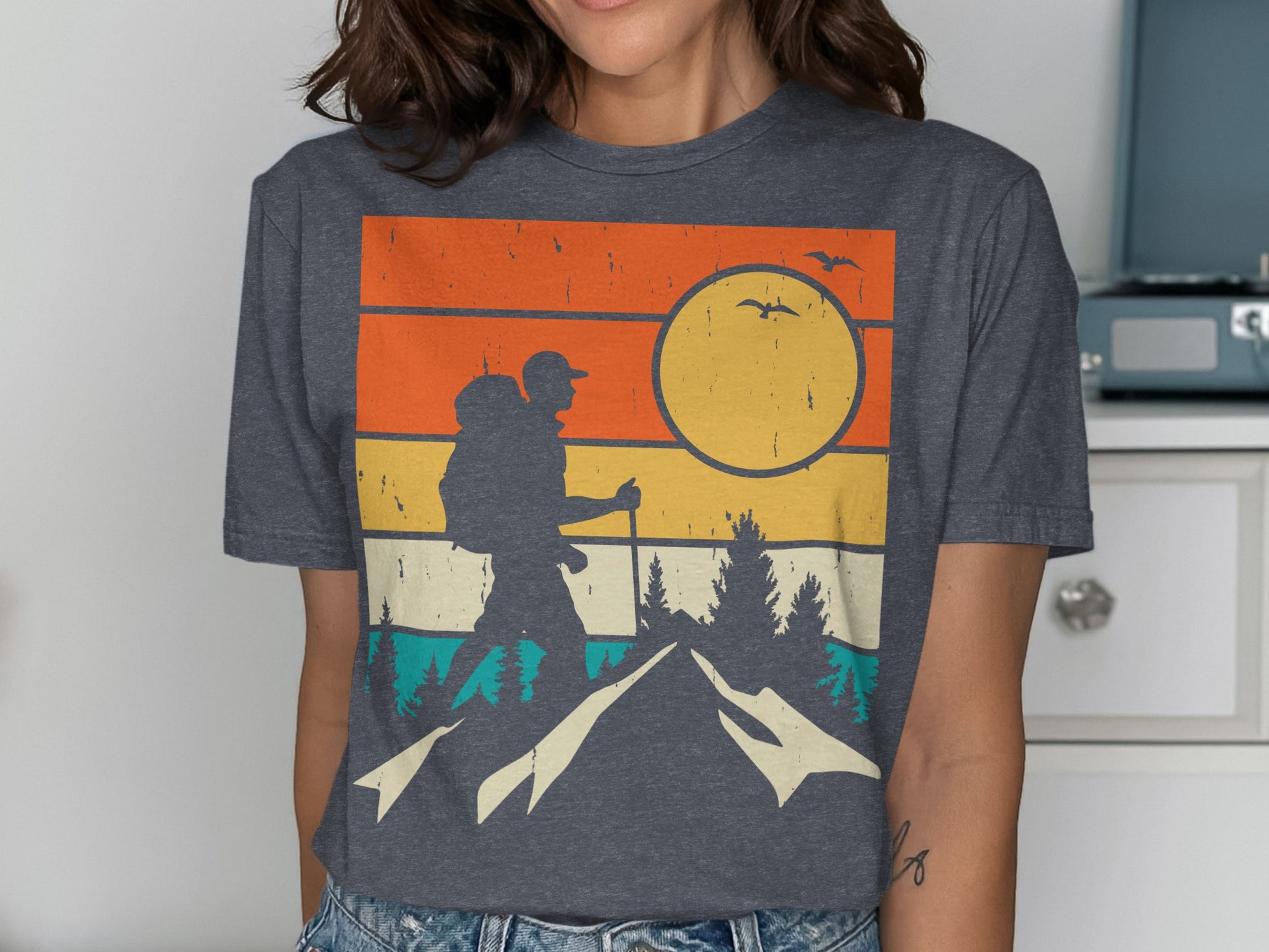 Retro sunset graphic of a hiker with a backpack in mountains.