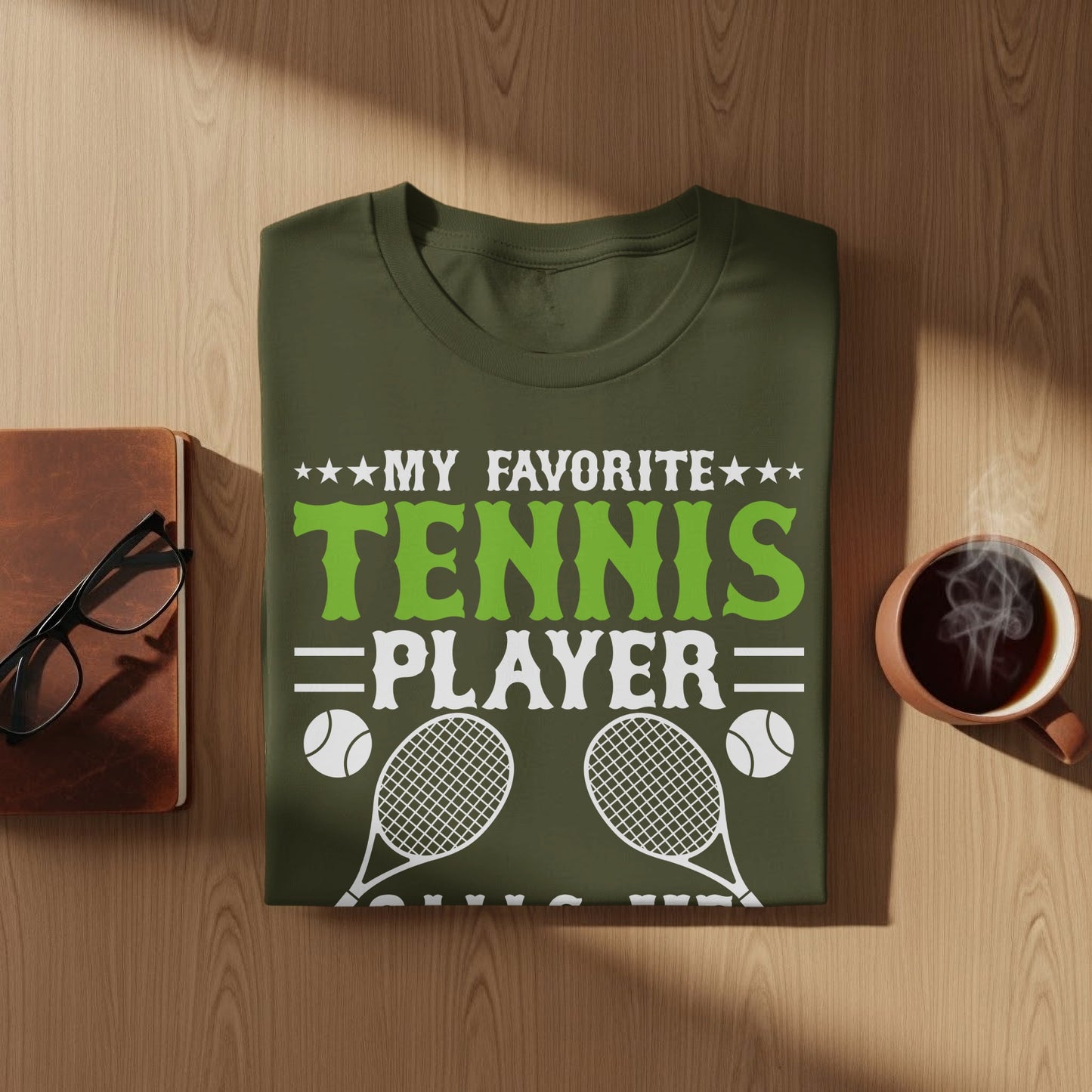 Olive green t-shirt with "My Favorite Player" text and tennis graphics.